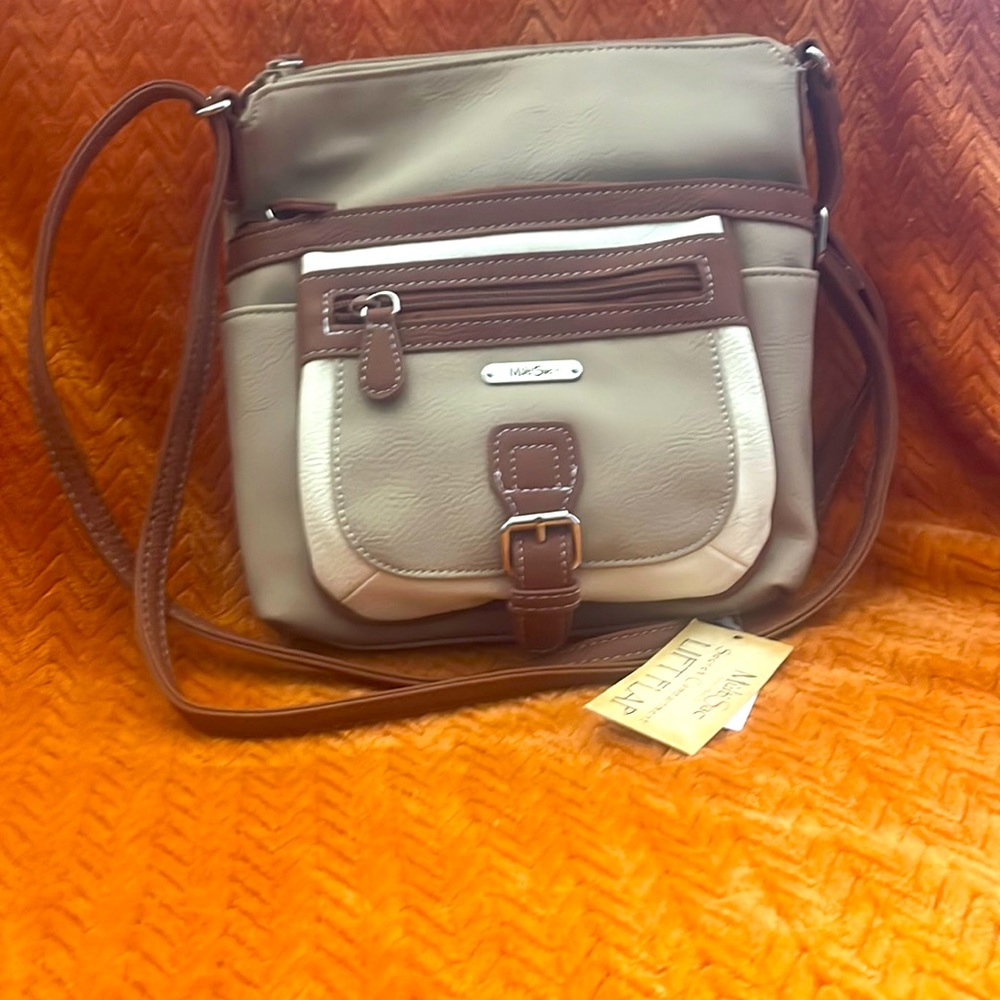 Cross body purse with adjustable strap.